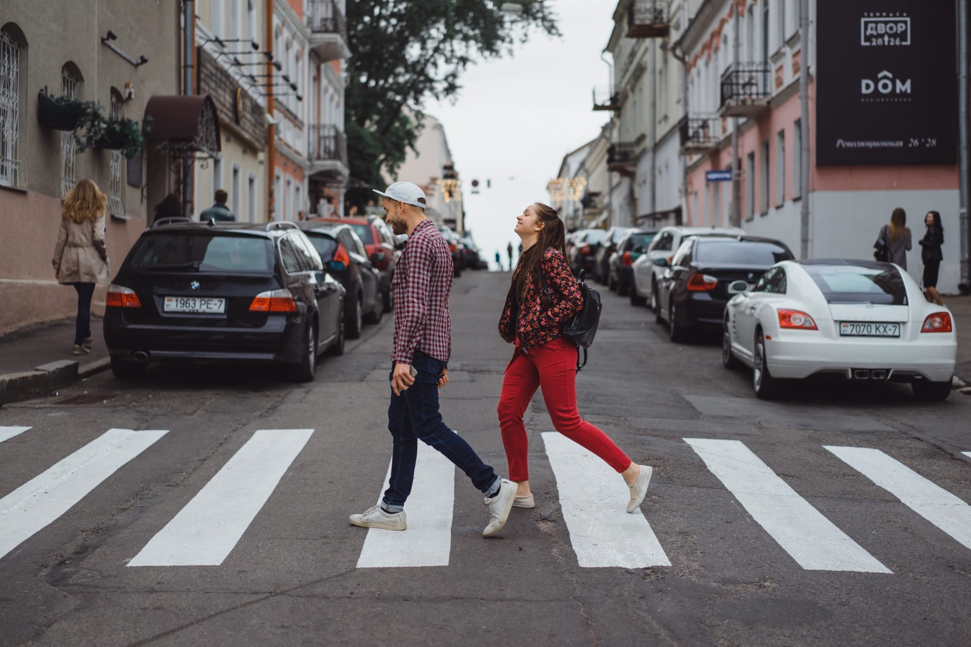 stylish-young-couple-posing-outdoors-young-man-with-bristle-cap-with-girl-with-long-hair-happy-young-people-are-walking-around-city-portrait-close-up